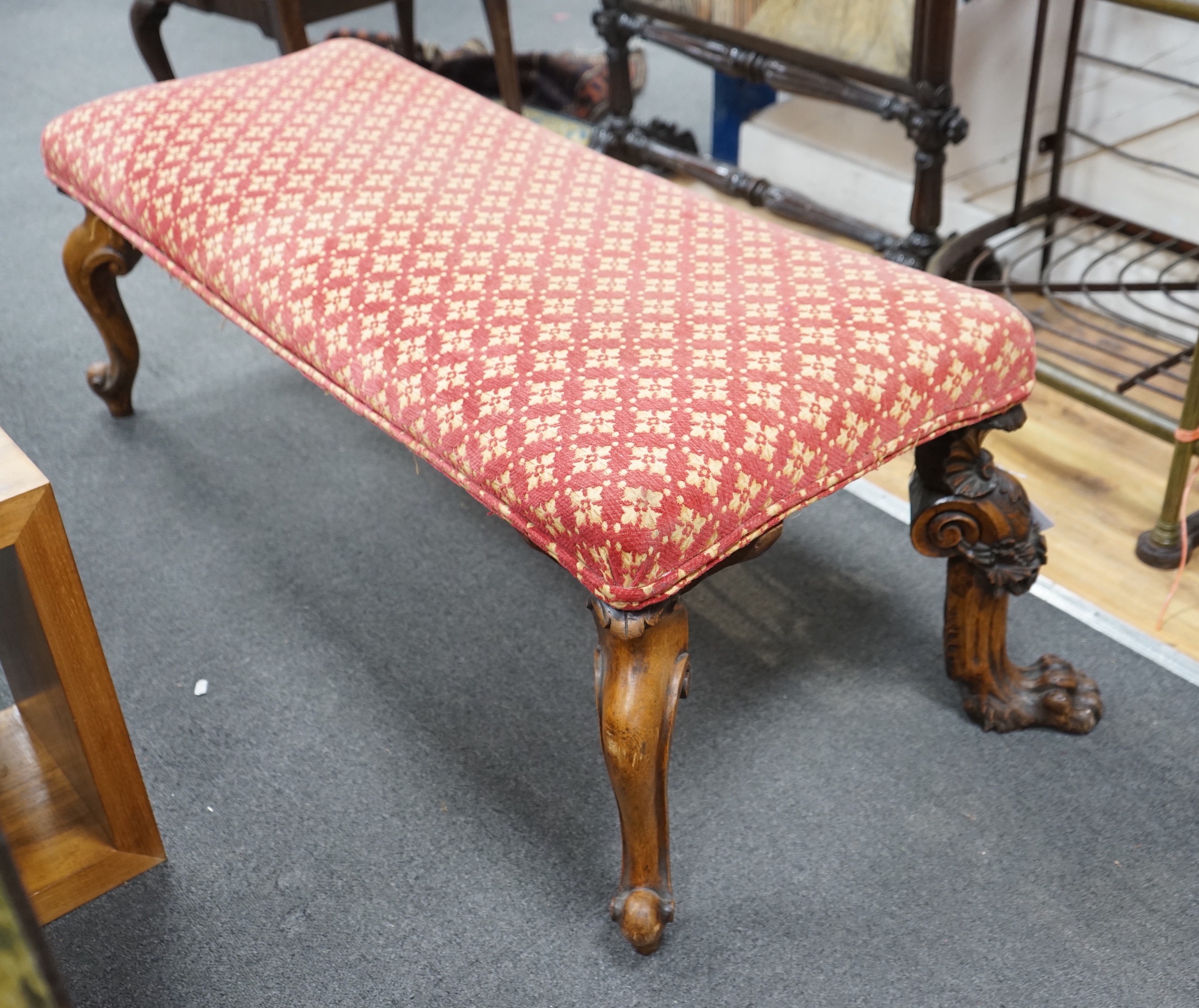 A Victorian window seat with carved oak lions paw feet, length 140cm, depth 62cm, height 48cm